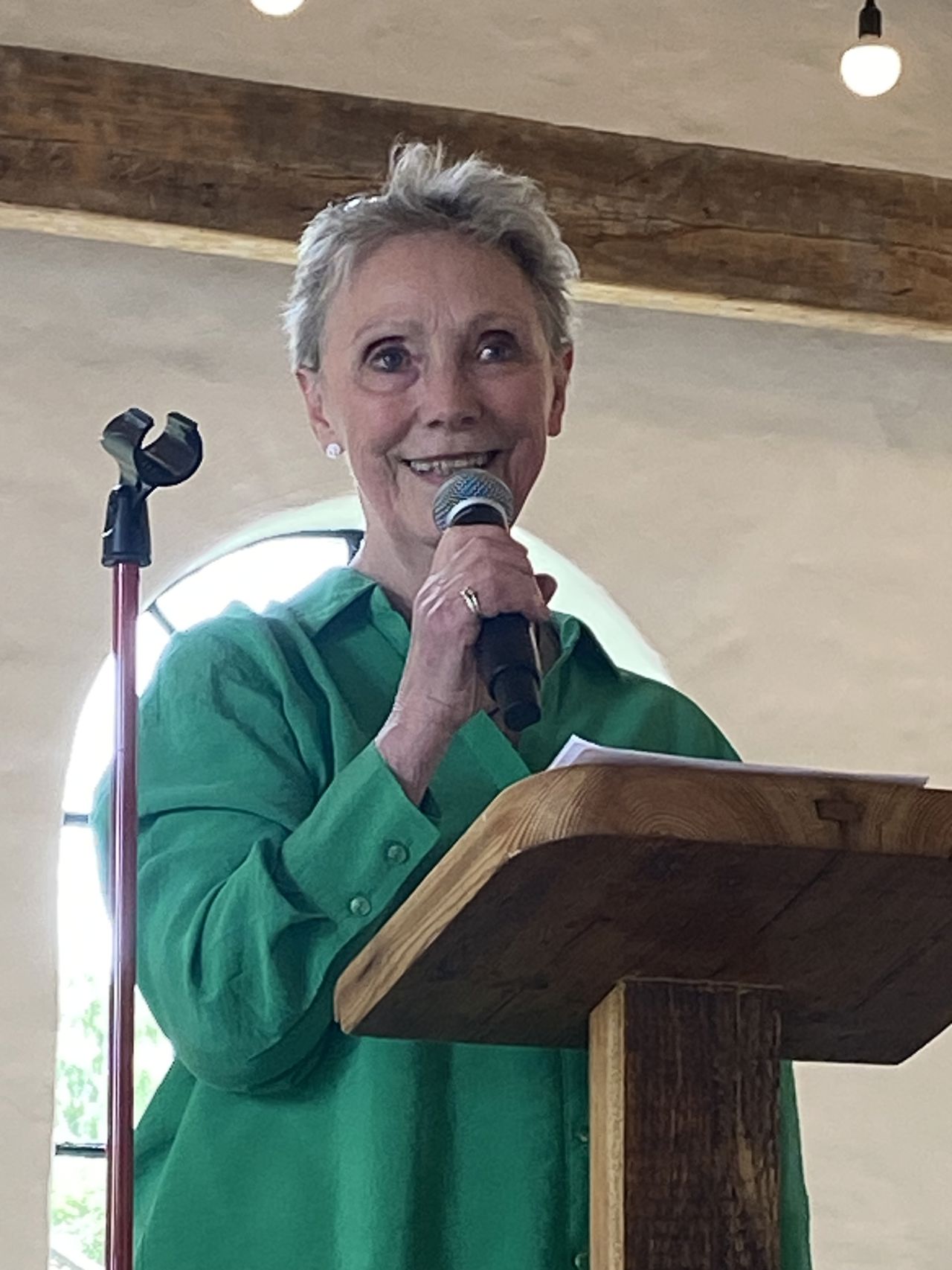 Kvinde står på talerstol og taler i mikrofon